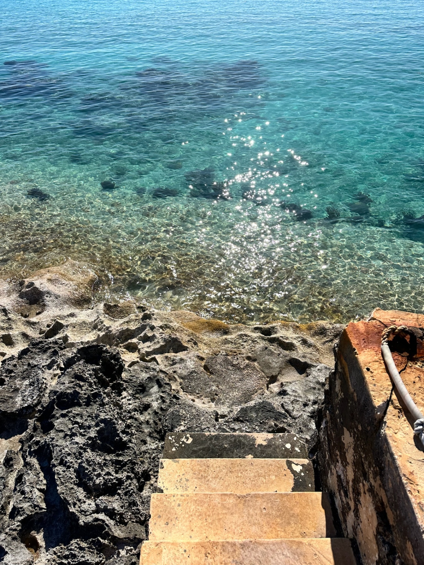Stone steps leading to crystal clear turquoise waters