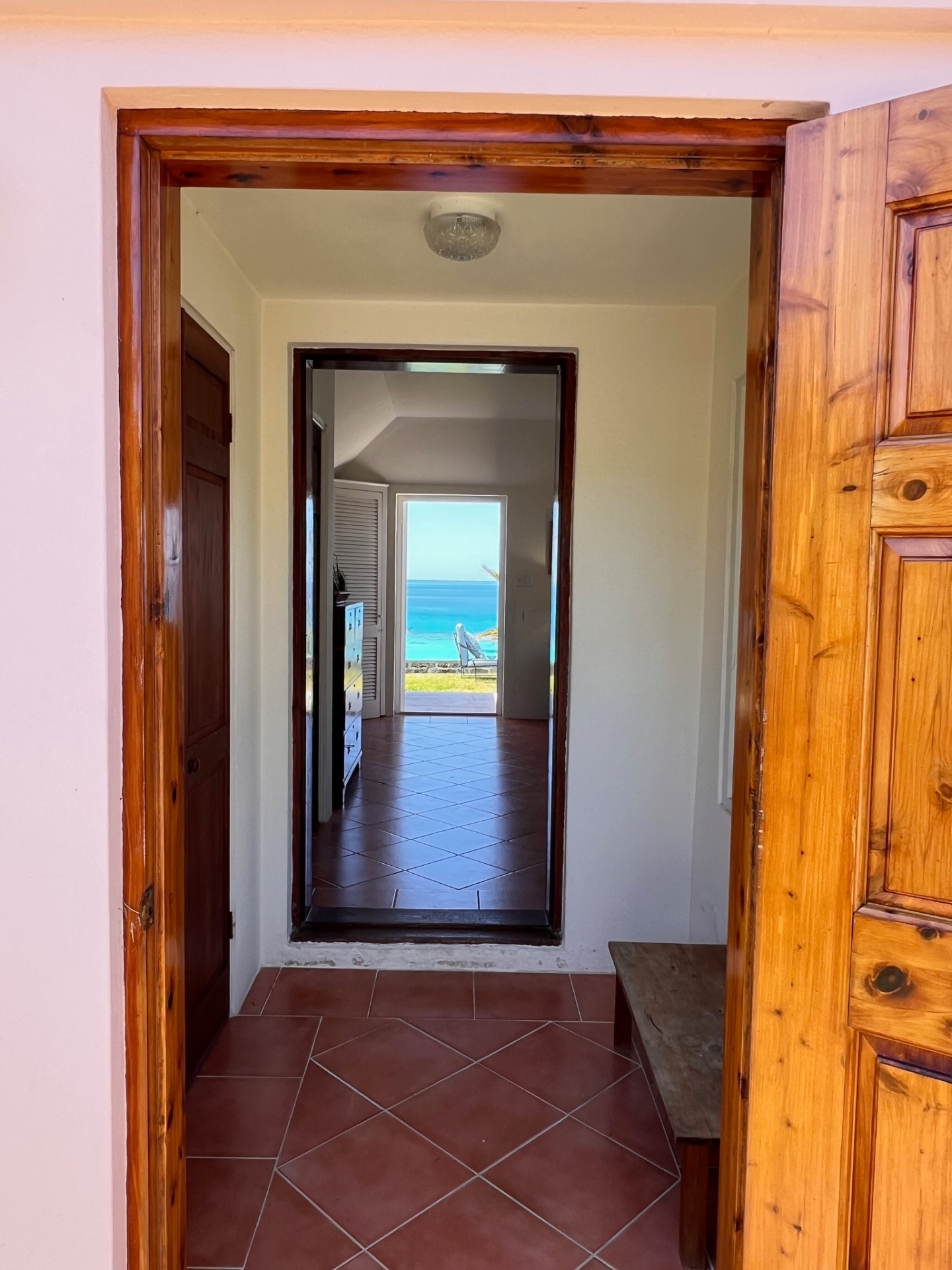 Hallway with ocean glimpse framed by beautiful woodwork